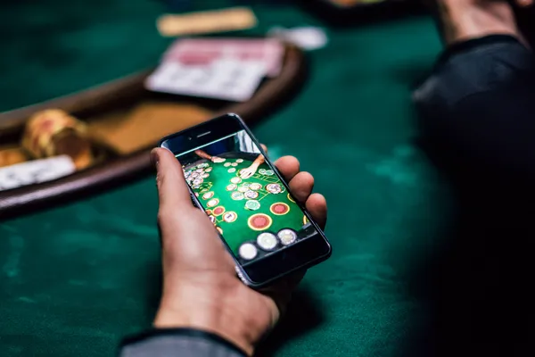 A glowing roulette wheel with cascading chips, symbolizing the engaging live and instant-win games available on AMJILI.